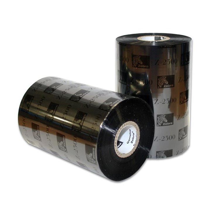 Two rolls of Zebra 2300 wax ribbon, one standing upright and the other lying on its side, both with black and white labeling.