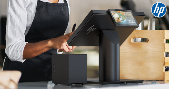 Person using a black HP POS system at a counter with an HP logo in the corner.